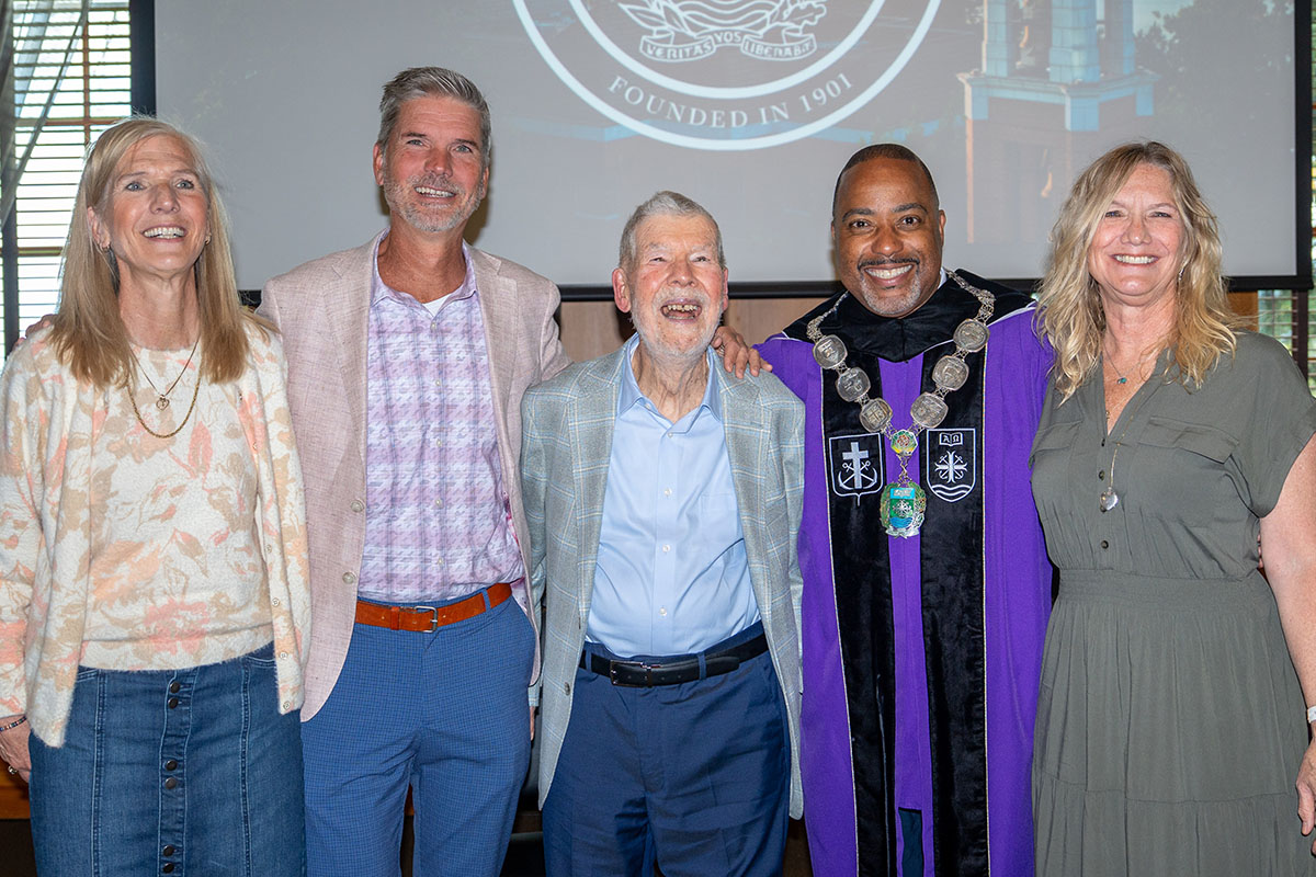 Professor Emeritus Helmut Becker poses smiling with his children and Dr. Kelly