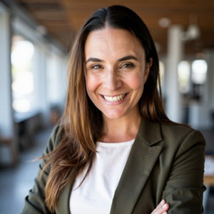 new faculty sasha standing while smiling