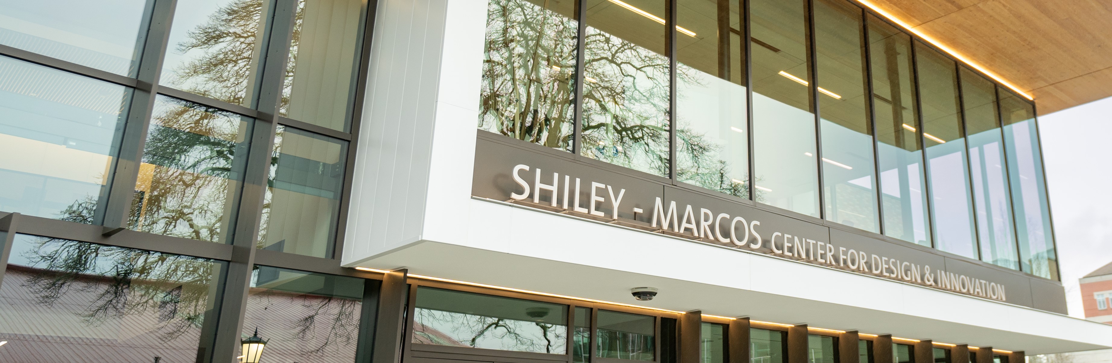 The exterior of the Shiley Marcos Center for Design and Innovation, a contemporary building with a window lined facade.