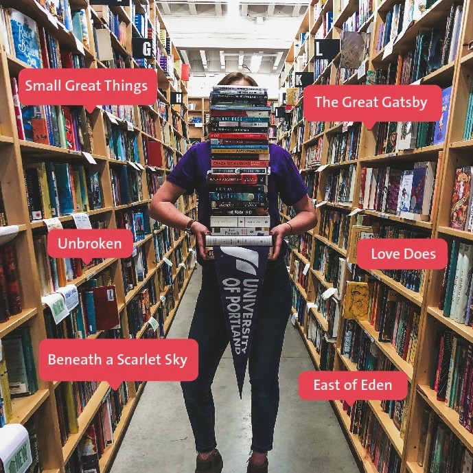 image of women holding stack of books