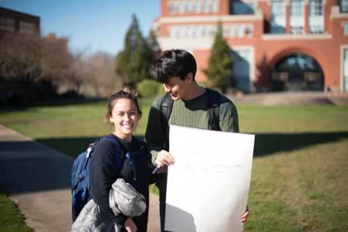 girl and boy, boy holding sign that says , "you're the most important thing to me"