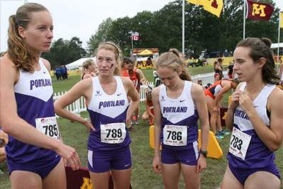 Circle of four women cross country runners