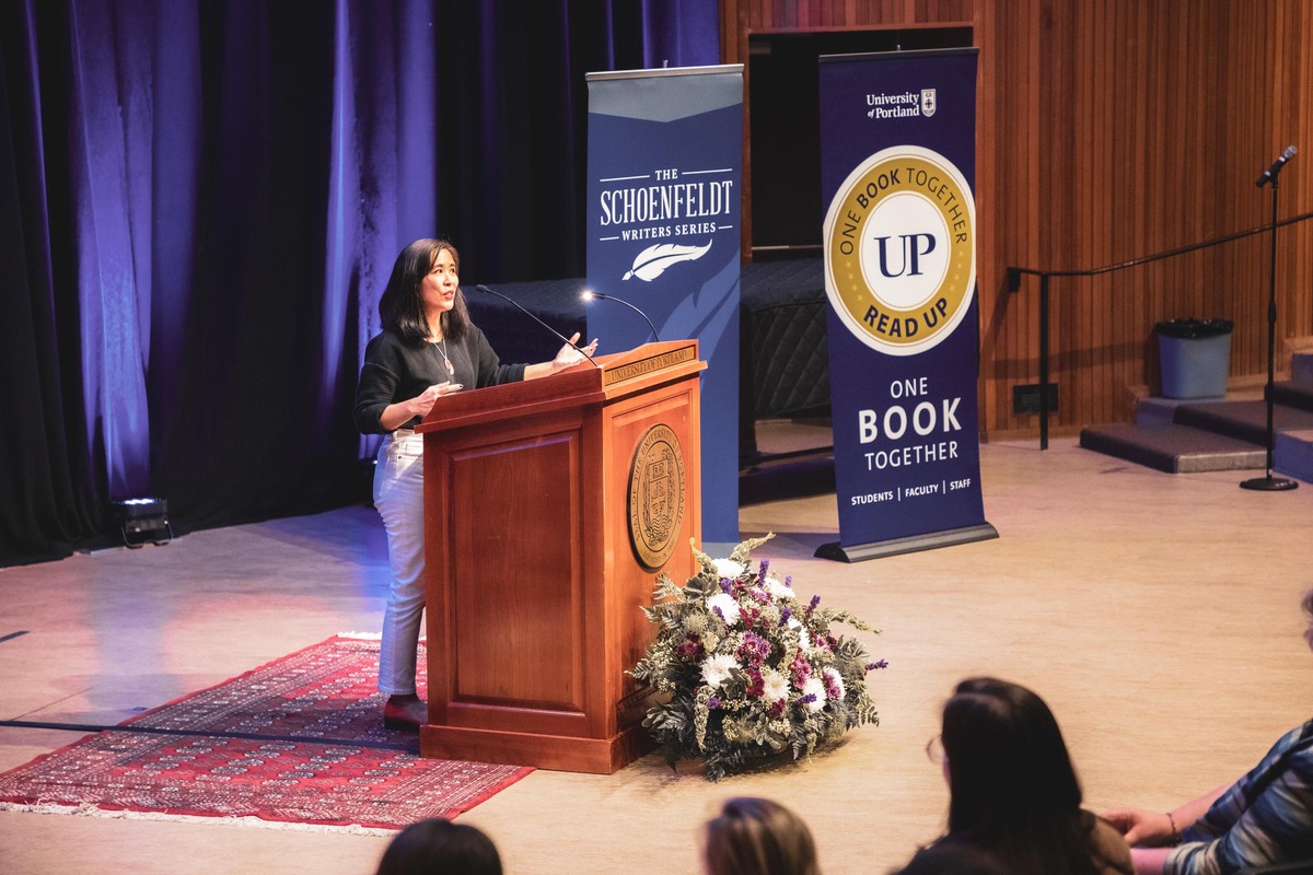 Author Lisa Ko gives a talk at a lectern in Dundon Berchtold Hall at University of Portland as part of ReadUP.