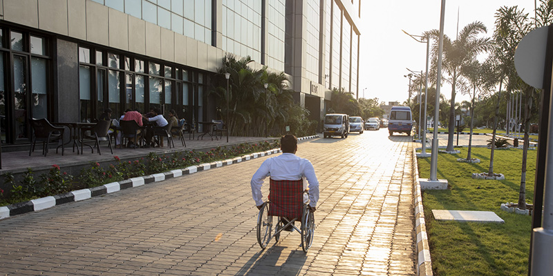 photo of man in wheelchair from behind