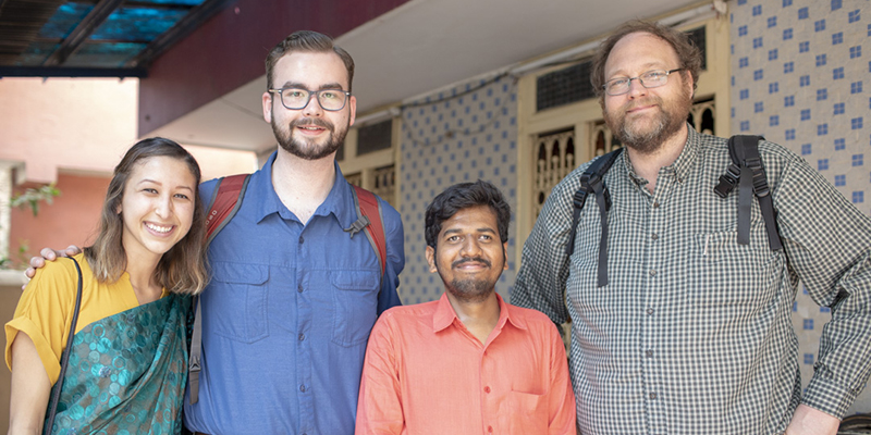 photo of four adults smiling