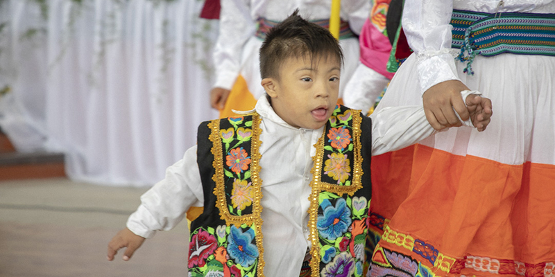 photo of young boy holding a woman's hand