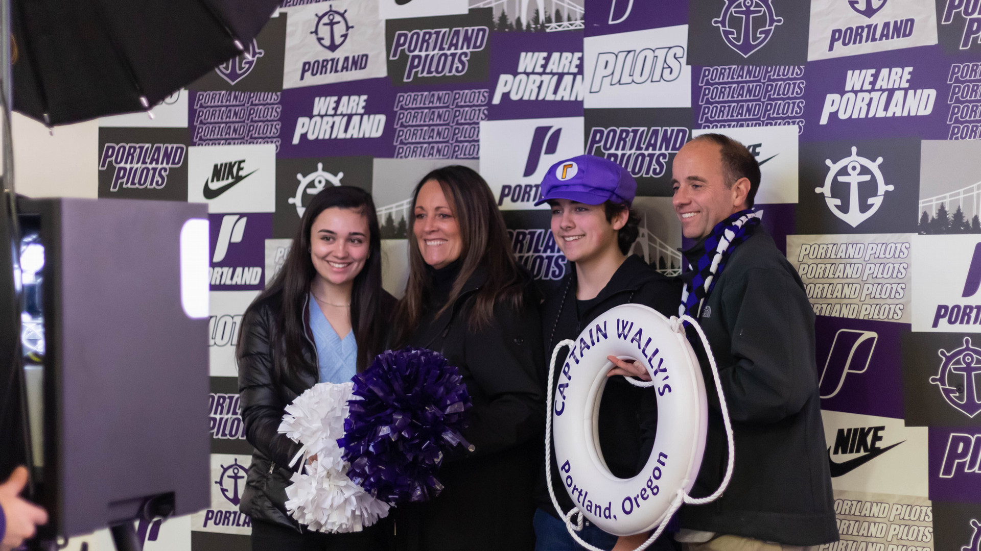 A Pilot family smiles for a picture during a family weekend event in the Chiles Center.