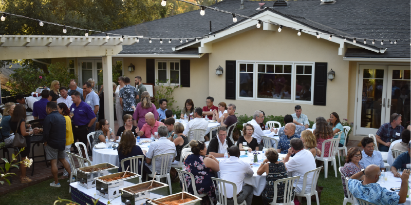 students and their families sitting at the Pasadena welcome reception 