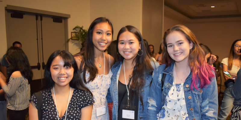 four students posing at welcome reception