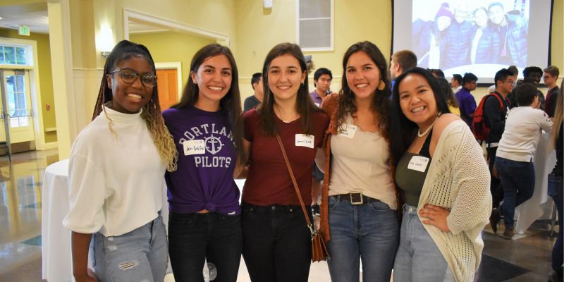 five students posing at welcome reception