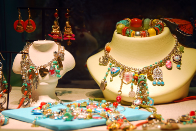 jewelry store windo with necklaces, earrings, and bracelets