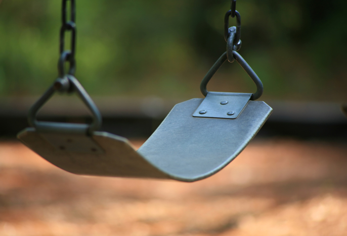 Empty swing-set seat in the park.