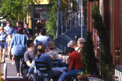 Diners sitting at tables at a sidewalk cafe in NW Portland.