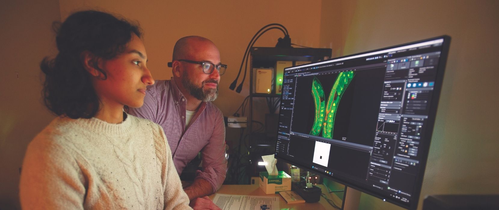 Rosario and Wynne look at microscope image