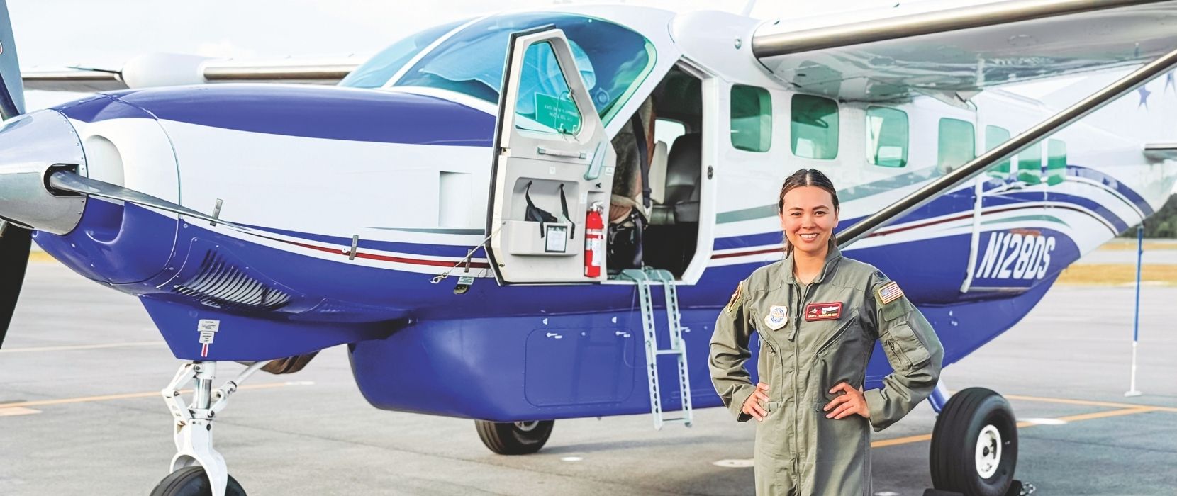 Mary Lea Bordelon stands in front of plane