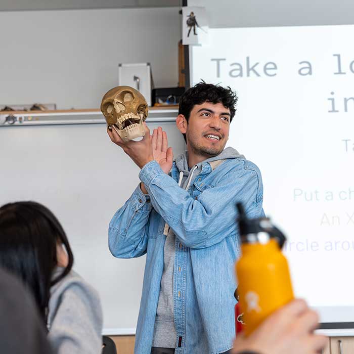 Daniel Mesquiti holds a skull
