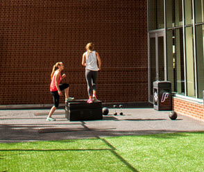 student working out in the outdoor courtyard