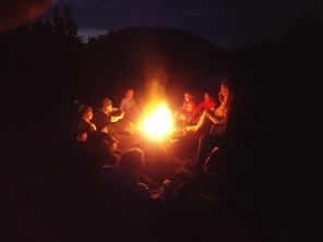 students sitting around a fire