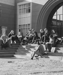 students sitting on steps facing quad