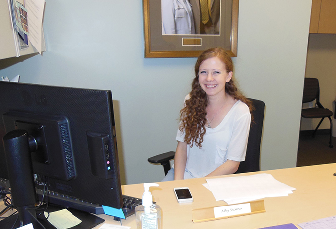Photo of student sitting at front desk of SARC, link to Parents and Families web page