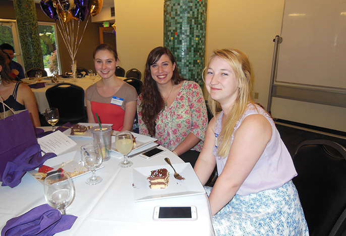 Photo of four students sitting around table, link to First Year Programs web page