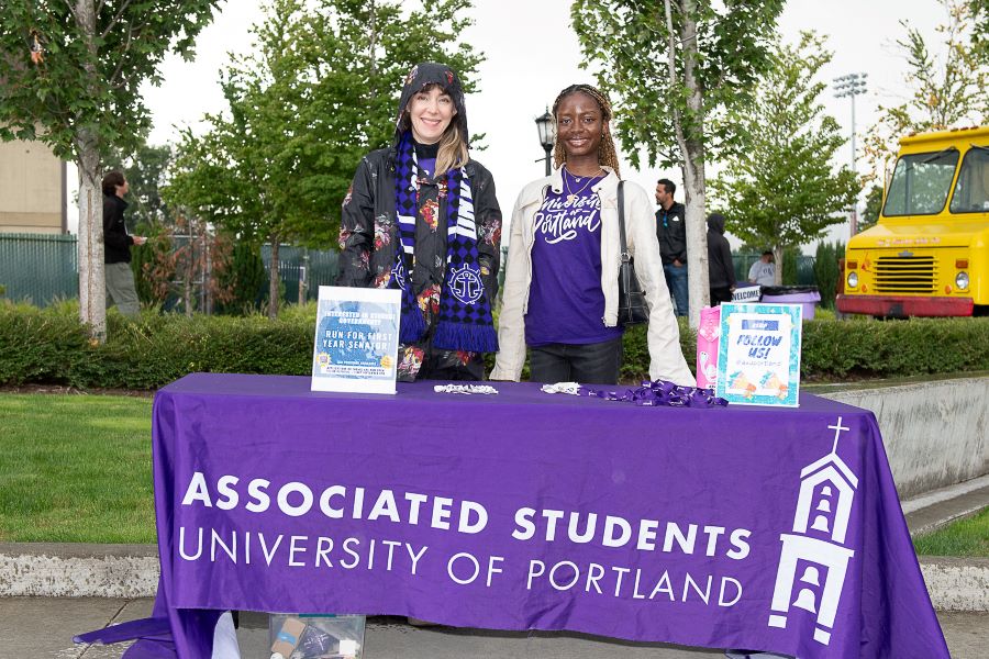 Two students stand at the ASUP recruitment table during the Bite on the Bluff events