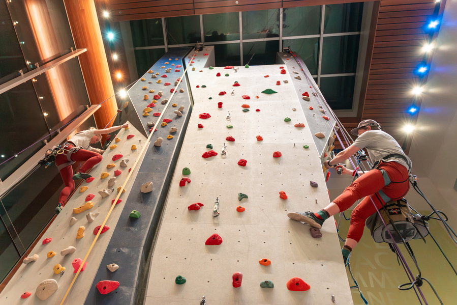 Students ascend the climbing wall at the Beauchamp recreation center at UP.