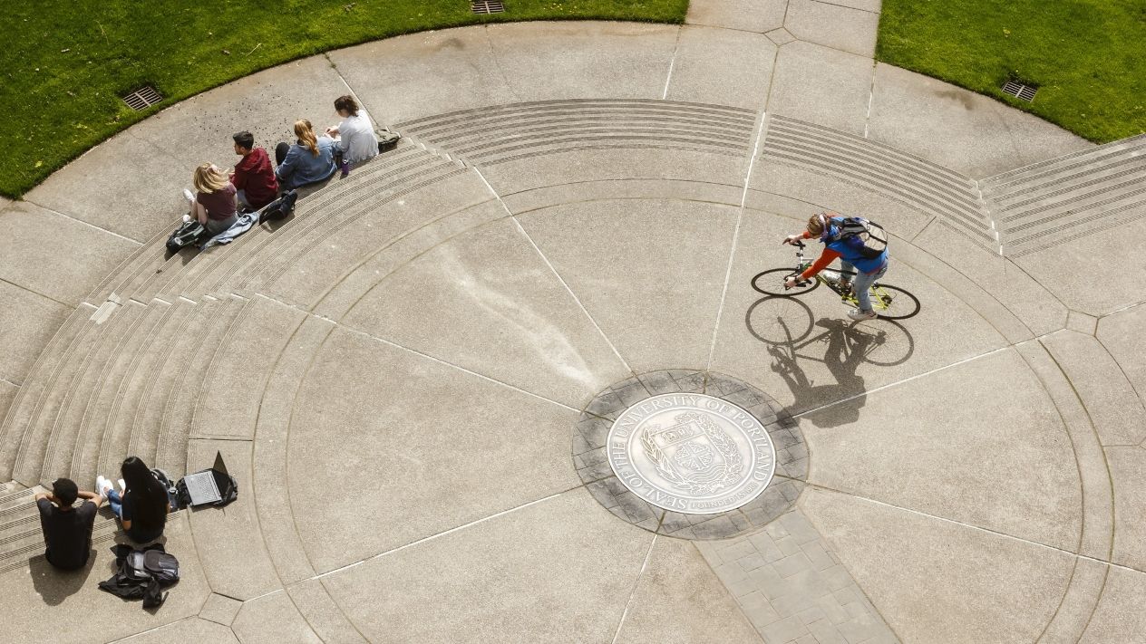 An overhead image of students interacting in the gathering space of a dormitory common area.