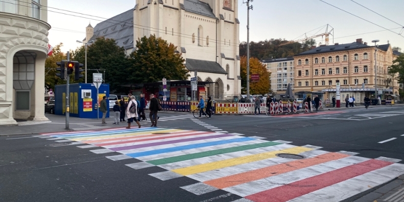 Salzburg street with the crosswalk painted in Pride flag colors