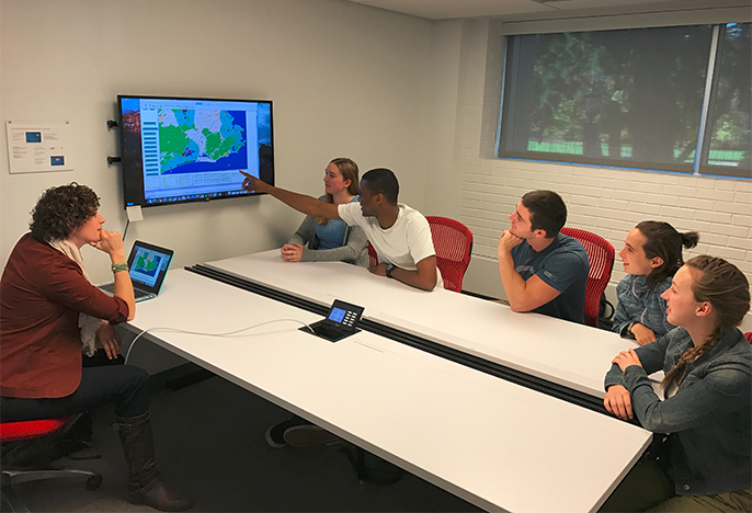 Professor discussing bioinformatics map with students