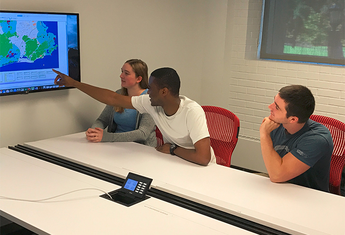 Students working around a conference table